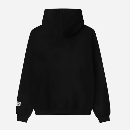Back view flat-lay photograph of the CELESTIC Black Star Hoodie on a white background. This premium heavyweight black cotton fleece pullover features a clean, minimalist back design, a structured double-lined hood, and ribbed cuffs and hem. A distinct woven CELESTIC brand patch with white text is visible on the left sleeve cuff.