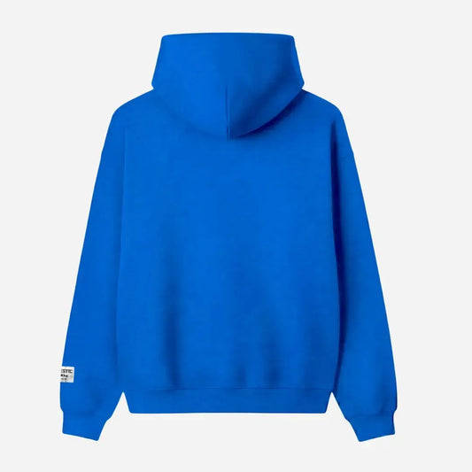Blue oversized full-zip hoodie back view laid flat on a white background. The premium heavyweight cotton fleece CELESTIC Blue Basic Hoodie shows a clean minimalist back with a structured double-lined hood and a woven brand patch visible on the left sleeve.