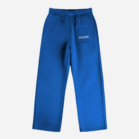 Blue oversized tracksuit sweatpants back view laid flat on a white background. The premium heavyweight cotton fleece CELESTIC Blue Basic pants feature an elasticated ribbed waistband and a right back pocket showcasing the signature white 'WORLDWIDE' embroidery.