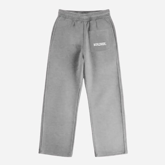 Back view of the CELESTIC Grey Basic sweatpants laid flat on a white background. These premium heavyweight grey cotton fleece pants feature a relaxed straight-leg silhouette and a back pocket with prominent white 'WORLDWIDE' logo embroidery.