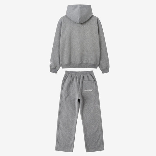 Back view of the full CELESTIC Grey Basic Tracksuit set laid flat on a white background. This premium heavyweight grey cotton fleece ensemble features an oversized zip-up hoodie with a structured hood and matching relaxed straight-leg sweatpants with white 'WORLDWIDE' embroidery on the back pocket.