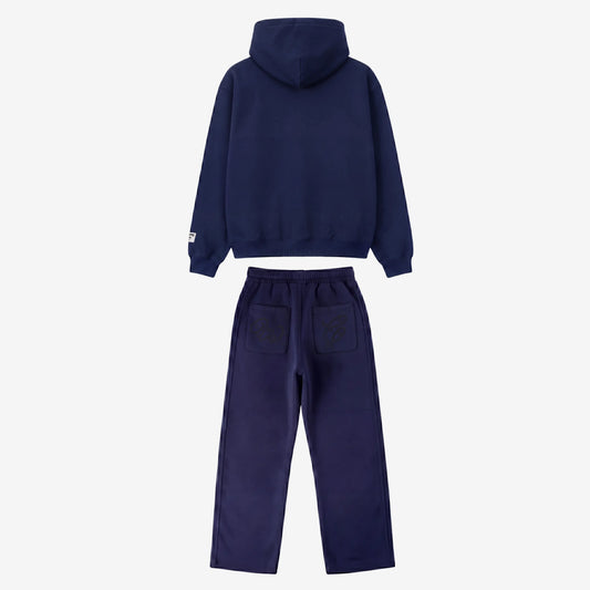 Back view of the full Navy Blue Outline Tracksuit set laid flat on a white background. Highlighting the premium heavyweight cotton fleece oversized hoodie with a clean back and structured hood, paired with matching sweatpants featuring two back pockets with distinctive 'W' and 'C' outline logo embroideries.