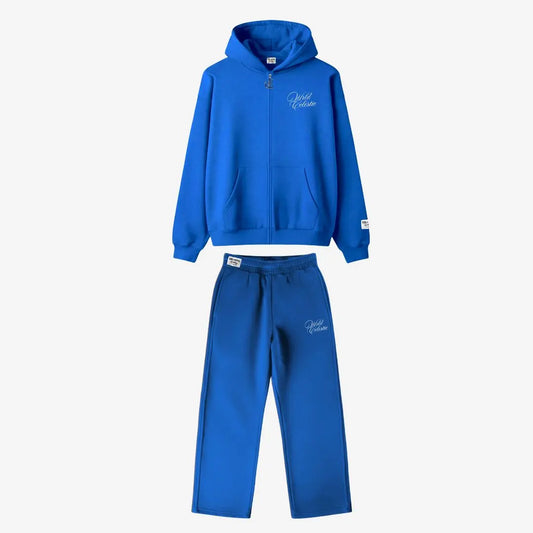 CELESTIC Blue Basic Tracksuit front view laid flat. Premium heavyweight blue cotton fleece two-piece set featuring an oversized full-zip hoodie and matching sweatpants with white script embroidery details on the left chest and thigh.