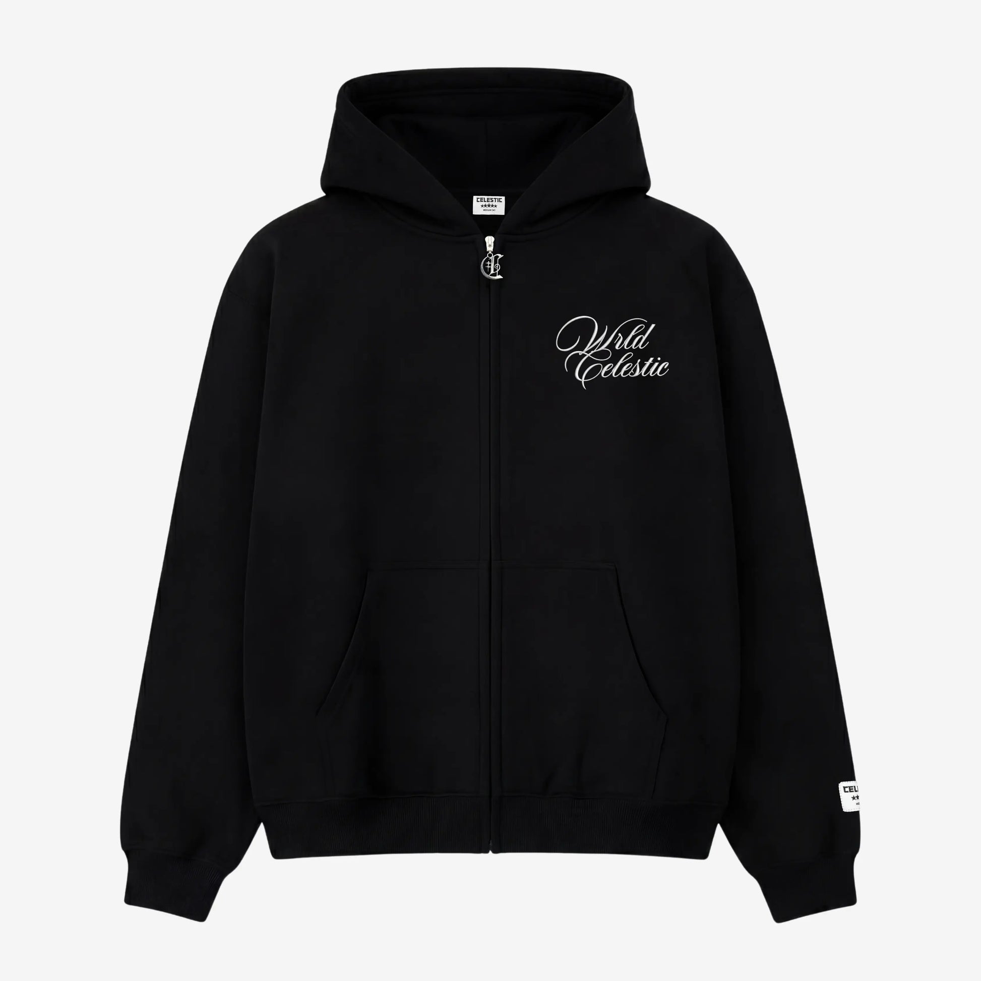 Front view of the CELESTIC Black Basic full-zip hoodie laid flat on a white background. Made from premium heavyweight black cotton fleece, it features white script logo embroidery on the chest, a custom silver metal 'C' zipper pull, and a woven brand patch on the left sleeve.