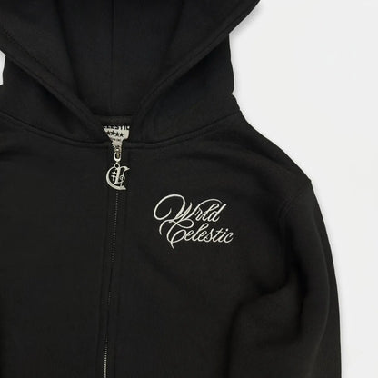 Detailed close-up of the CELESTIC Black Basic zip-up hoodie. Highlighting the premium heavyweight black cotton fleece material, the elegant white script logo embroidery on the chest, and the custom silver metal 'C' zipper pull.