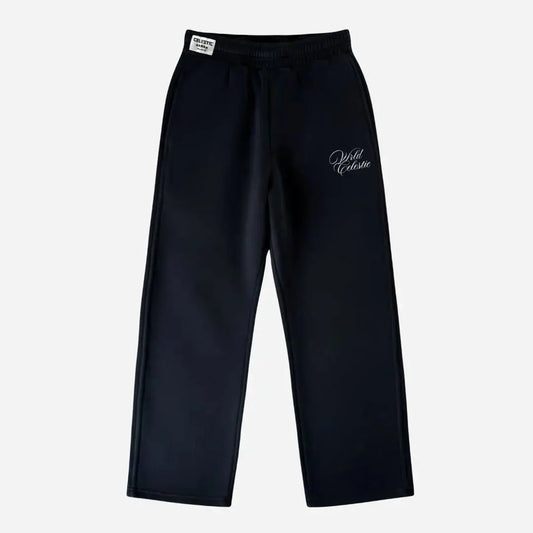 Front view of the CELESTIC Black Basic sweatpants laid flat on a white background. These premium heavyweight black cotton fleece pants feature a relaxed straight-leg fit, an elasticated waistband with a white woven brand label, and elegant white script logo embroidery on the left thigh.