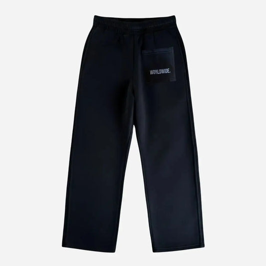 Back view of the CELESTIC Black Basic sweatpants laid flat on a white background. These premium black cotton fleece pants feature a relaxed straight-leg silhouette and a back pocket with prominent white script logo embroidery.