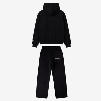 Back view of the full CELESTIC Black Basic Tracksuit set laid flat on a white background. This premium heavyweight black cotton fleece ensemble features an oversized zip-up hoodie with a structured hood and matching relaxed straight-leg sweatpants with white 'WORLDWIDE.' embroidery on the back pocket.