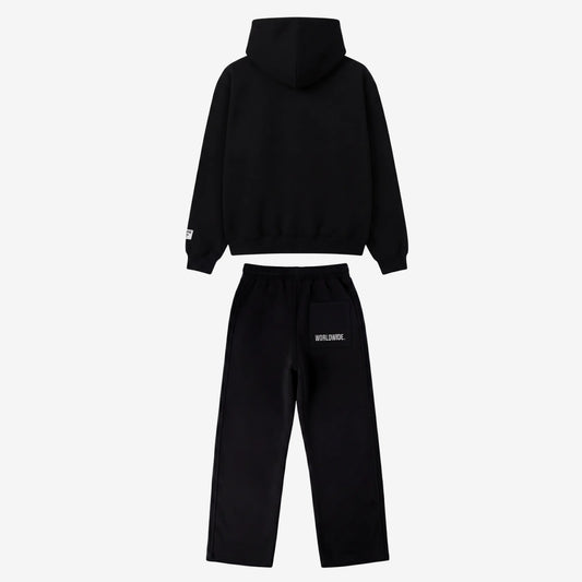 Back view of the full CELESTIC Black Basic Tracksuit set laid flat on a white background. This premium heavyweight black cotton fleece ensemble features an oversized zip-up hoodie with a structured hood and matching relaxed straight-leg sweatpants with white 'WORLDWIDE.' embroidery on the back pocket.