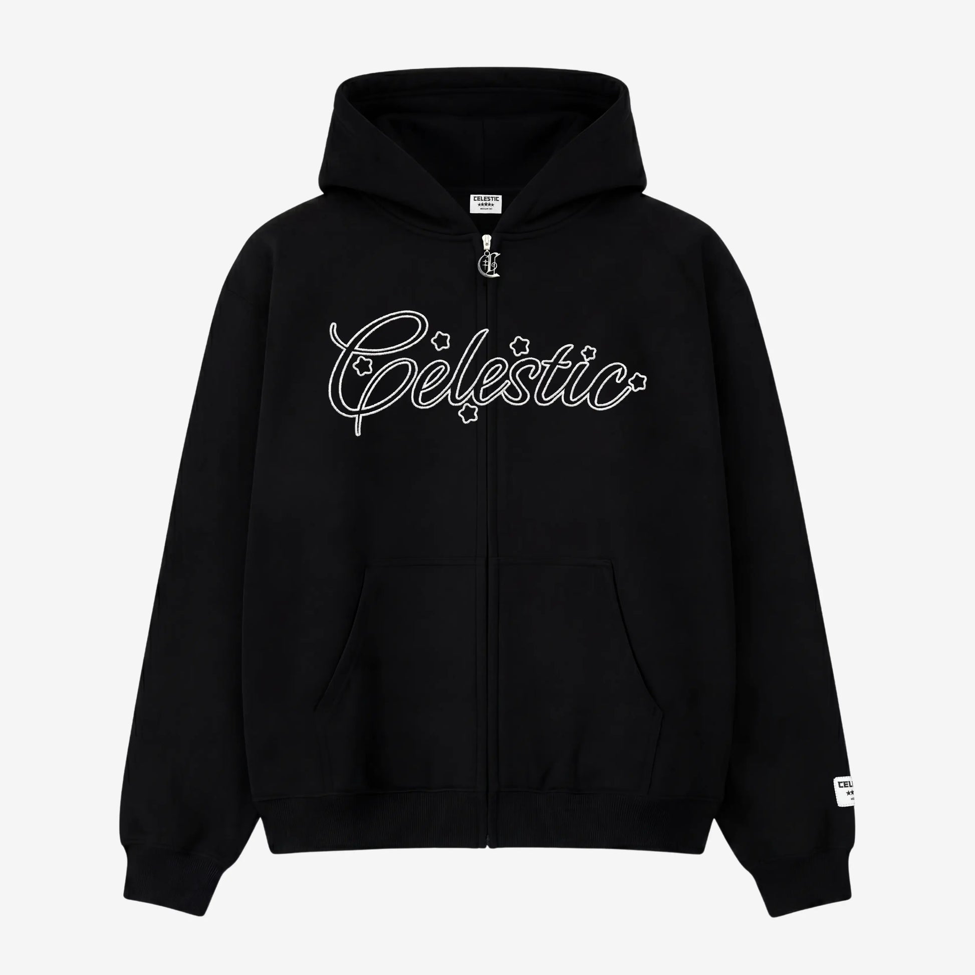 Black oversized zip-up hoodie front view laid flat on a white background. The premium heavyweight cotton fleece CELESTIC Black Outline Hoodie features a large white outline logo embroidery with stars across the chest, a custom metal 'C' zipper pull, front pockets, and a woven brand patch on the left sleeve.
