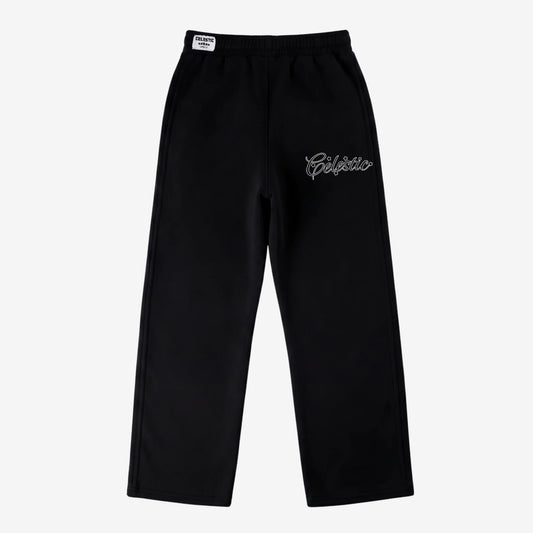Black oversized tracksuit sweatpants laid flat on a white background. The premium heavyweight cotton fleece pants feature an elasticated waistband with a woven Celestic brand label, and the signature white outline logo embroidery with star accents on the left thigh.