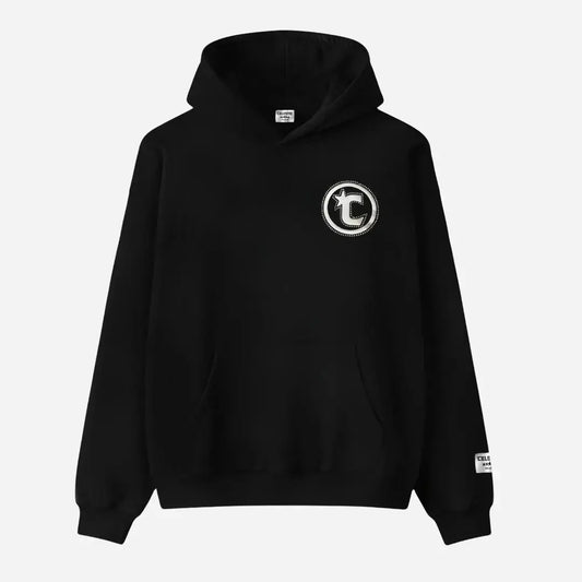 Front view flat-lay of the CELESTIC Black Star Hoodie on a white background. This premium heavyweight black cotton fleece pullover hoodie features a classic kangaroo pocket, structured hood, and ribbed cuffs and hem. The design is highlighted by a prominent white circular 'C' star logo embroidery on the left chest and a woven CELESTIC brand patch on the left sleeve cuff.
