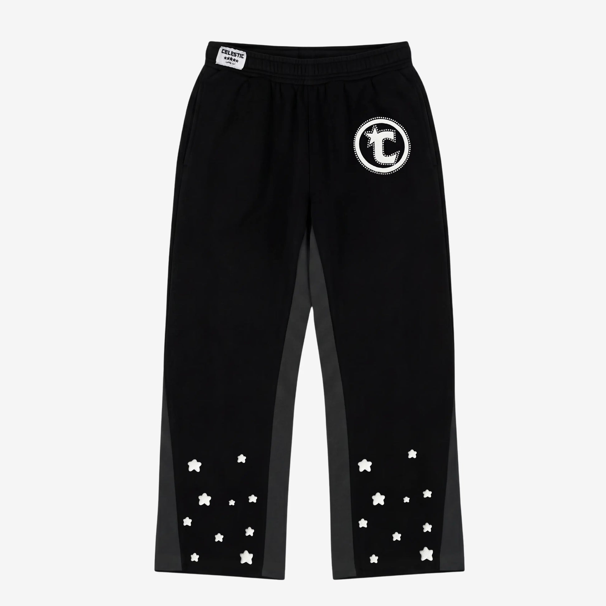 Front view flat-lay photograph of the CELESTIC Black Star Pants on a white background. These premium heavyweight black cotton fleece sweatpants feature a relaxed straight-leg fit, contrasting grey side panels, and multiple scattered white embroidered stars on the lower legs. Details include a prominent white circular 'C' star logo embroidery on the left thigh and a woven CELESTIC brand label on the elastic waistband.