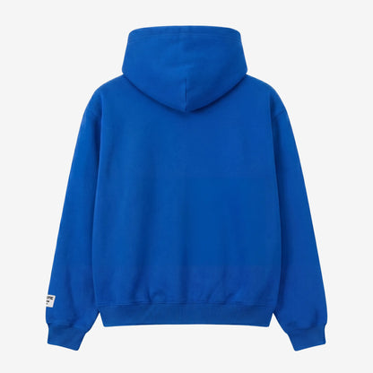 Blue oversized full-zip hoodie back view laid flat on a white background. The premium heavyweight cotton fleece CELESTIC Blue Basic Hoodie shows a clean minimalist back with a structured double-lined hood and a woven brand patch visible on the left sleeve.