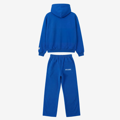 Back view of the CELESTIC Blue Basic Tracksuit laid flat on a white background. Premium heavyweight blue cotton fleece set showing a clean minimalist hoodie back, structured hood, and matching sweatpants featuring white 'WORLDWIDE' embroidery on the back pocket.