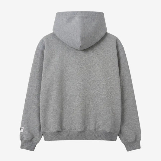 Back view of the CELESTIC Grey Basic zip-up hoodie laid flat on a white background. The premium heavyweight grey cotton fleece is shown with a structured double-lined hood and a clean minimalist back, featuring a woven brand patch on the left sleeve.