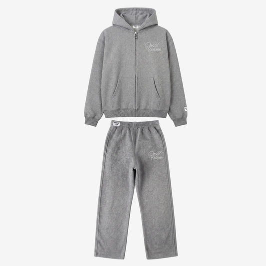 Main product image of the CELESTIC Grey Basic Tracksuit set. This premium heavyweight grey cotton fleece ensemble includes an oversized full-zip hoodie with white script logo embroidery on the chest, a custom metal 'C' zipper pull, and matching relaxed straight-leg sweatpants with thigh embroidery and a branded elastic waistband.