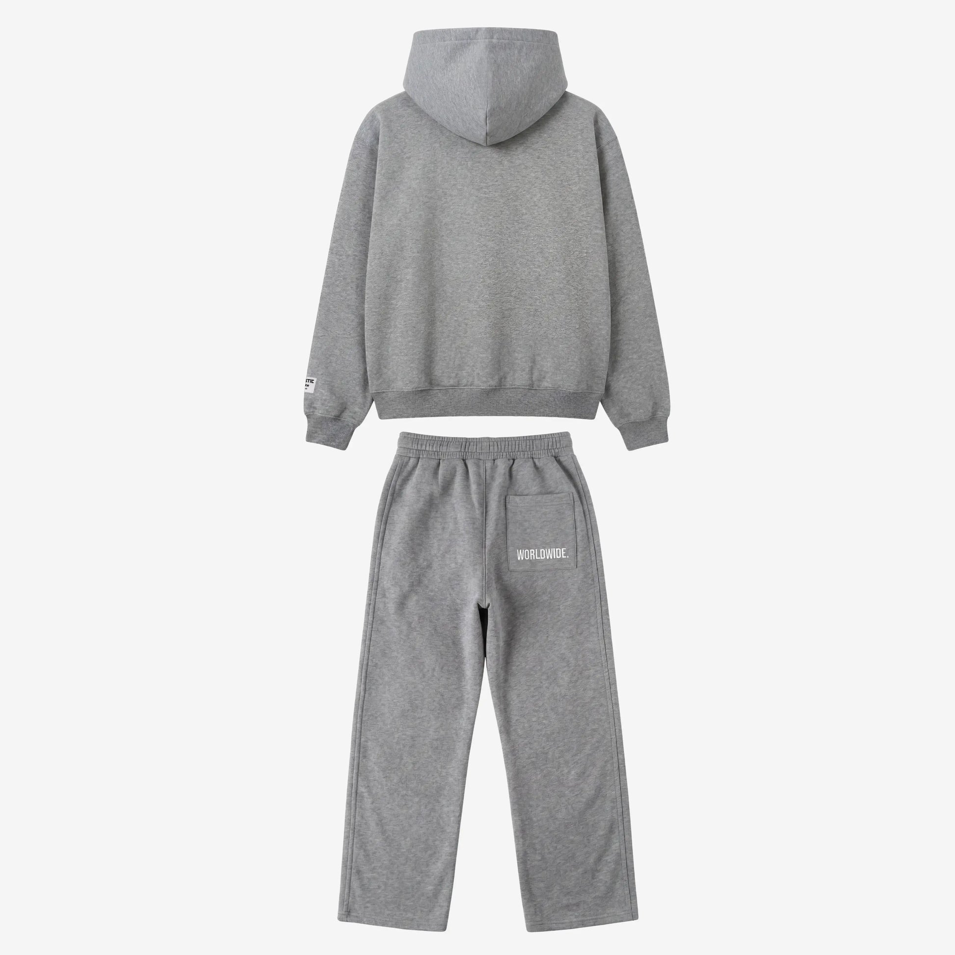 Back view of the full CELESTIC Grey Basic Tracksuit set laid flat on a white background. This premium heavyweight grey cotton fleece ensemble features an oversized zip-up hoodie with a structured hood and matching relaxed straight-leg sweatpants with white 'WORLDWIDE' embroidery on the back pocket.
