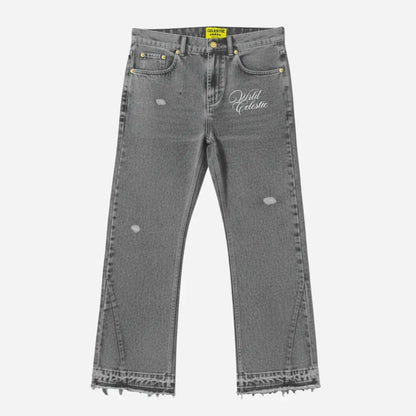 Grey flared jeans front view. Premium washed distressed grey denim pants featuring lower leg panel stitching, frayed raw hems, subtle rips, and white Celestic embroidered logo on the thigh.