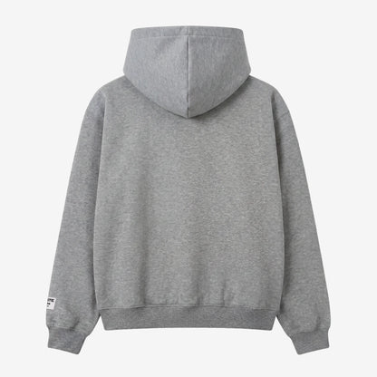 Back view flat-lay photograph of the CELESTIC Grey Star Hoodie on a white background. This premium heather grey cotton fleece pullover features a clean minimalist back design, a structured double-lined hood, and ribbed cuffs and hem. A distinct white woven CELESTIC brand patch is visible on the left sleeve cuff.