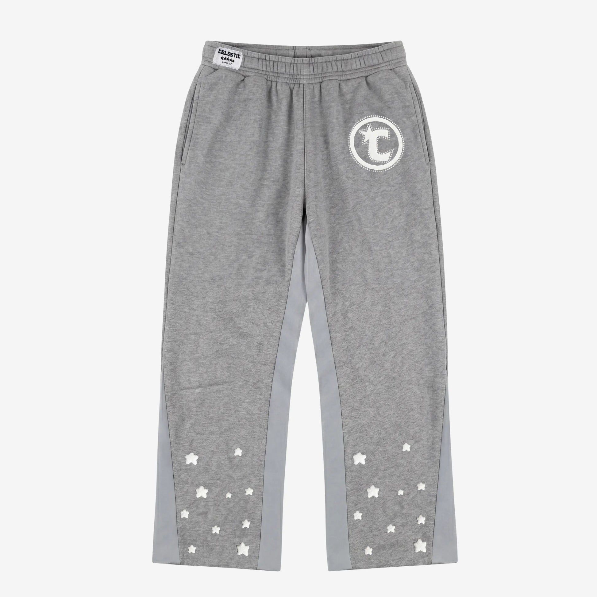 Front view flat-lay photograph of the CELESTIC Grey Star Pants on a white background. These premium heather grey cotton fleece sweatpants feature light grey side panels and a relaxed fit. A white circular 'C' star logo is featured on the left thigh, while the lower legs are detailed with multiple scattered white embroidered stars. A white woven CELESTIC brand label is visible on the elastic waistband.