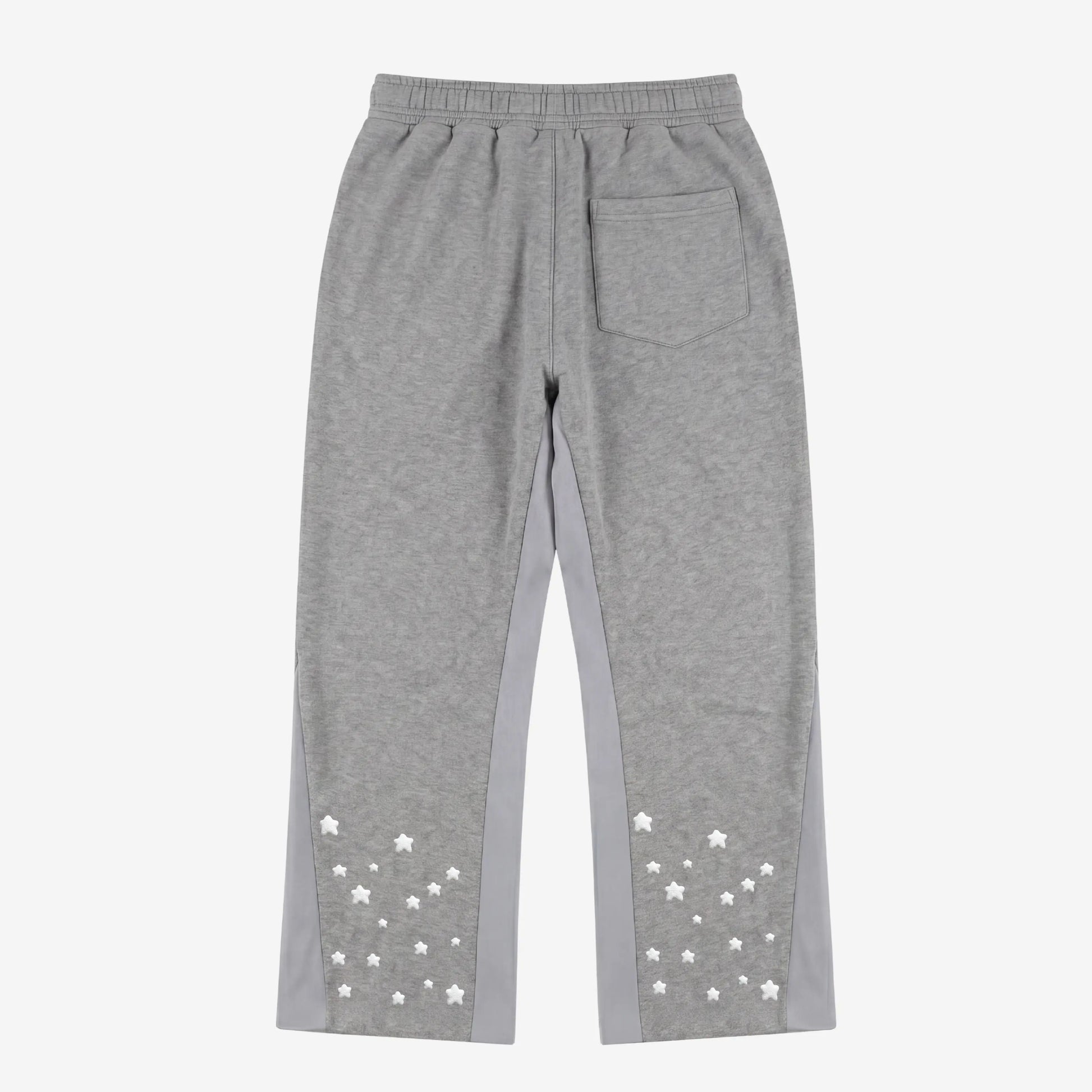 Back view flat-lay photograph of the CELESTIC Grey Star Pants on a white background. These premium heather grey cotton fleece sweatpants feature light grey side panels, a relaxed fit, and a single back pocket on the right side. The lower back of both legs is detailed with multiple scattered white embroidered stars, highlighting the unique streetwear aesthetic of the Star collection.