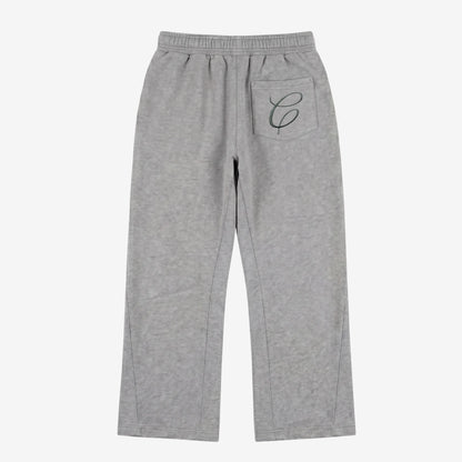 Back view flat-lay photograph of the CELESTIC Grey Zipper Flared Pants on a white background. These premium heather grey cotton fleece sweatpants feature a relaxed flared-leg fit and a single right back pocket detailed with an elegant black embroidered 'C' script logo. The image showcases the high-quality stitching and the wide, flared leg silhouette from the rear.