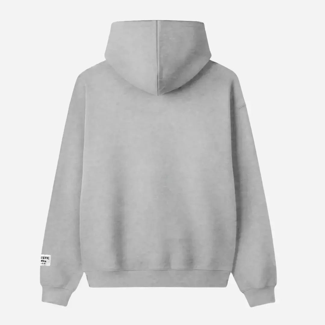 Back view flat-lay photograph of the CELESTIC Grey Zipper Hoodie on a white background. This premium heather grey cotton fleece zip-up features a clean, minimalist back design, a structured double-lined hood, and ribbed cuffs and hem. A distinct white woven CELESTIC brand patch is visible on the left sleeve cuff.
