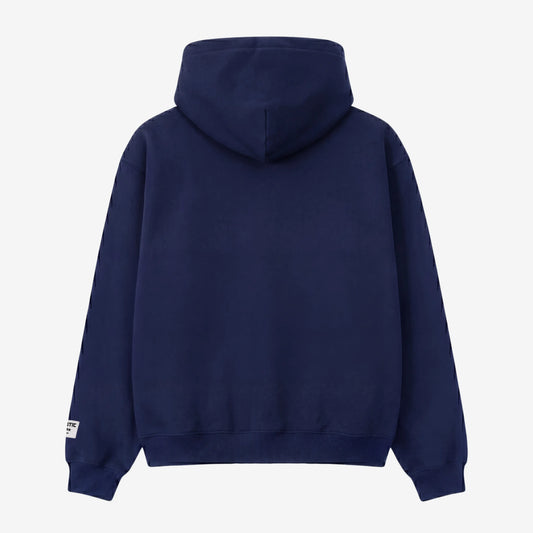Back view of the CELESTIC Navy Blue Outline zip-up hoodie laid flat on a white background. The premium heavyweight cotton fleece material is shown with a structured double-lined hood and a clean minimalist back, featuring a woven brand patch on the left sleeve.