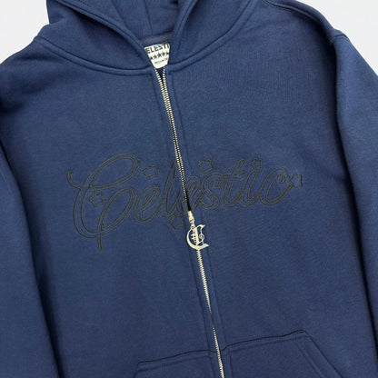 Detailed close-up of the CELESTIC Navy Blue Outline zip-up hoodie. Featuring the large tonal 'Celestic' outline embroidery with star details, the custom silver metal 'C' zipper pull, and the premium heavyweight navy blue cotton fleece fabric.