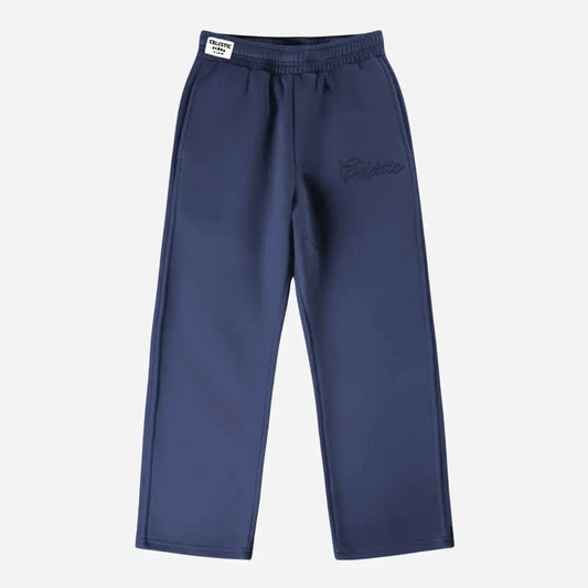 Navy blue oversized tracksuit sweatpants front view laid flat on a white background. The premium heavyweight cotton fleece CELESTIC Navy Blue Outline pants feature an elasticated ribbed waistband with a white woven brand label and tonal 'Celestic' outline logo embroidery on the left thigh.