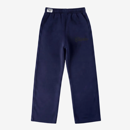 Navy blue oversized tracksuit sweatpants front view laid flat on a white background. The premium heavyweight cotton fleece CELESTIC Navy Blue Outline pants feature an elasticated ribbed waistband with a white woven brand label and tonal 'Celestic' outline logo embroidery on the left thigh.