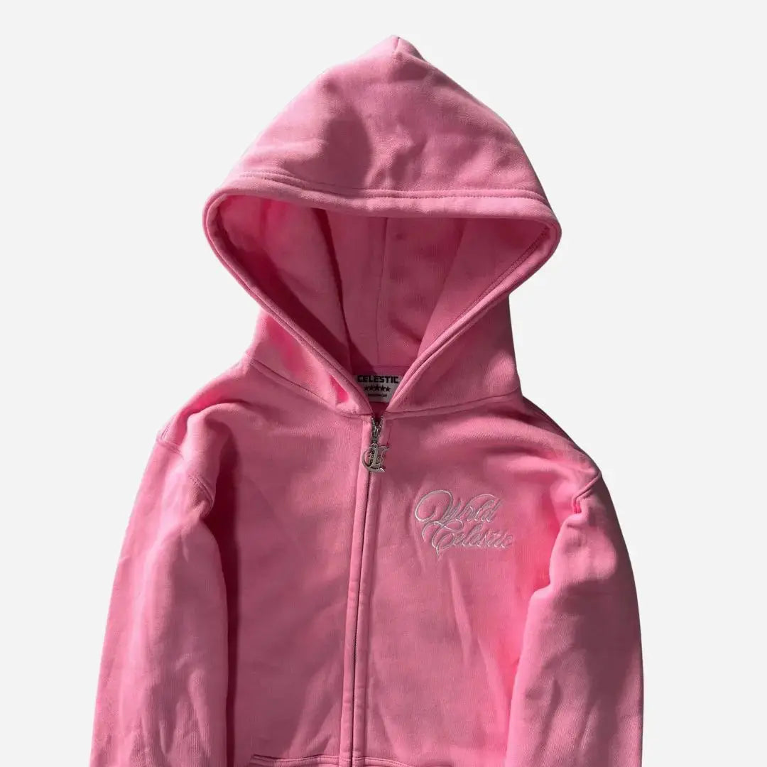 Detailed close-up view of the CELESTIC Pink Basic zip-up hoodie. Highlighting the premium heavyweight pink cotton fleece fabric, the structured hood, the elegant white script logo embroidery on the chest, and the custom metal 'C' zipper pull.