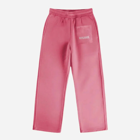 Pink oversized tracksuit sweatpants back view laid flat on a white background. The premium heavyweight cotton fleece CELESTIC Pink Basic pants feature an elasticated ribbed waistband and a right back pocket showcasing the signature white 'WORLDWIDE' embroidery.