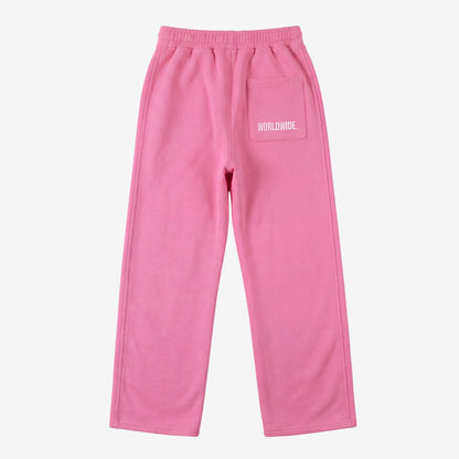 Pink oversized tracksuit sweatpants back view laid flat on a white background. The premium heavyweight cotton fleece CELESTIC Pink Basic pants feature an elasticated ribbed waistband and a right back pocket showcasing the signature white 'WORLDWIDE' embroidery.