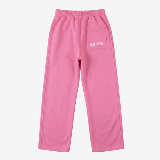 Pink oversized tracksuit sweatpants back view laid flat on a white background. The premium heavyweight cotton fleece CELESTIC Pink Basic pants feature an elasticated ribbed waistband and a right back pocket showcasing the signature white 'WORLDWIDE' embroidery.