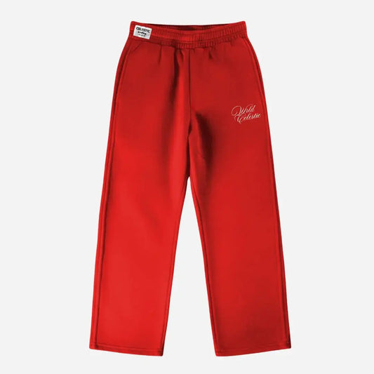 Red oversized tracksuit sweatpants front view laid flat on a white background. The premium heavyweight cotton fleece CELESTIC Red Basic pants feature an elasticated ribbed waistband with a woven brand label, prominent side panel seams, and elegant white script logo embroidery on the left thigh.