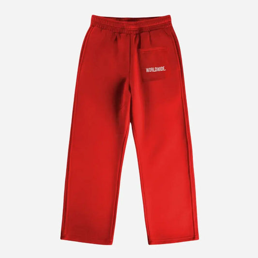 Red oversized tracksuit sweatpants back view laid flat on a white background. The premium heavyweight cotton fleece CELESTIC Red Basic pants feature an elasticated ribbed waistband and a right back pocket showcasing the signature white 'WORLDWIDE' embroidery.