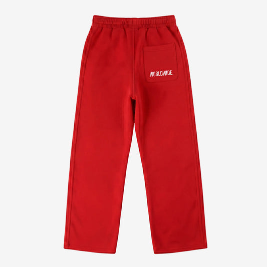 Red oversized tracksuit sweatpants back view laid flat on a white background. The premium heavyweight cotton fleece CELESTIC Red Basic pants feature an elasticated ribbed waistband and a right back pocket showcasing the signature white 'WORLDWIDE' embroidery.