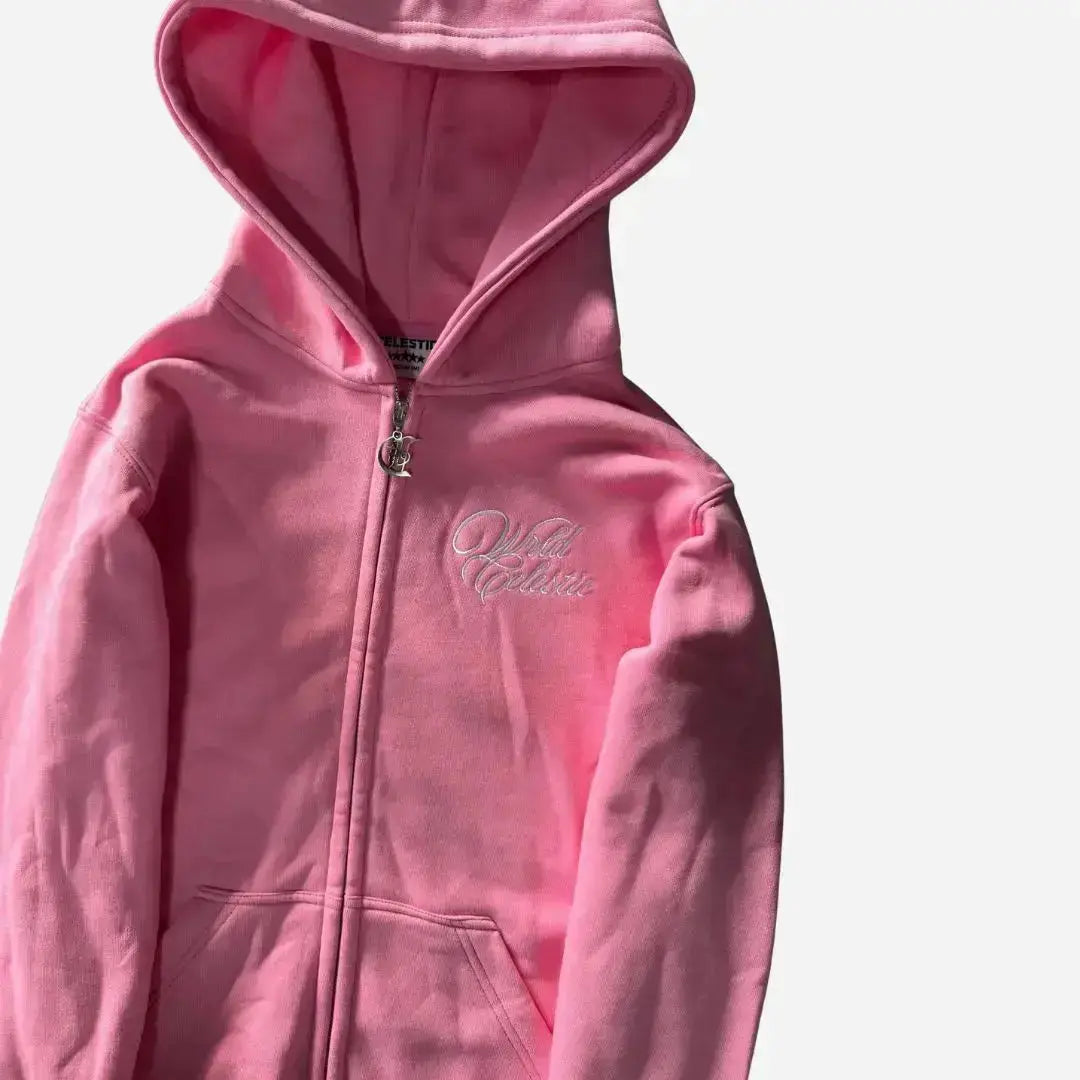Close-up view of the Celestic Pink Basic Hoodie. Highlighting the premium heavyweight pink cotton fleece, white script embroidery on the chest, and the custom metal 'C' logo zipper pull on the zip-up hoodie.