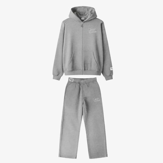 Main product image of the CELESTIC Grey Basic Tracksuit set. This premium heavyweight grey cotton fleece ensemble includes an oversized full-zip hoodie with white script logo embroidery on the chest, a custom metal 'C' zipper pull, and matching relaxed straight-leg sweatpants with thigh embroidery and a branded elastic waistband.