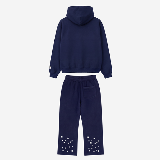 Back view of the CELESTIC Navy Blue Star Tracksuit laid flat on a white background. Heavyweight navy blue cotton fleece pullover hoodie with structured hood and matching flared pants with embroidered stars around the leg openings.